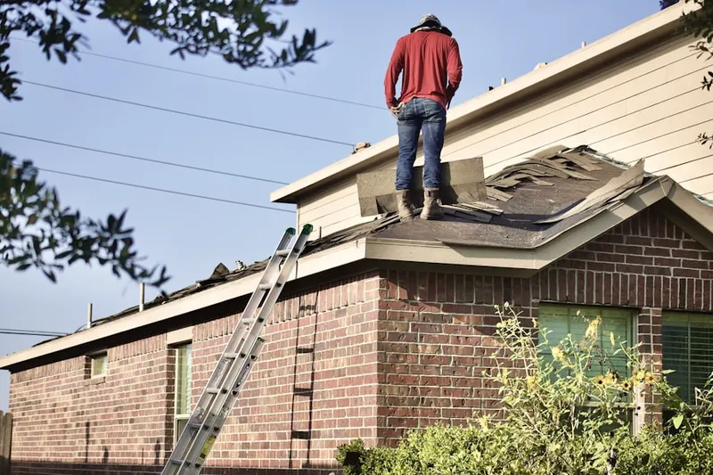 Professional roofer working on a residential roof in Harbor City